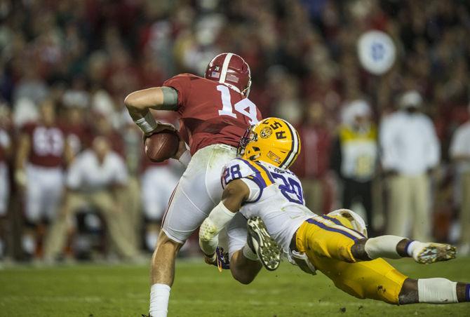 LSU senior safety Jalen Mills (28) tackles quarterback Jake Coker (14) during the Tigers' 30-16 defeat against The University of Alabama on Saturday, Nov. 7, 2015 in the Bryant-Denny Stadium.