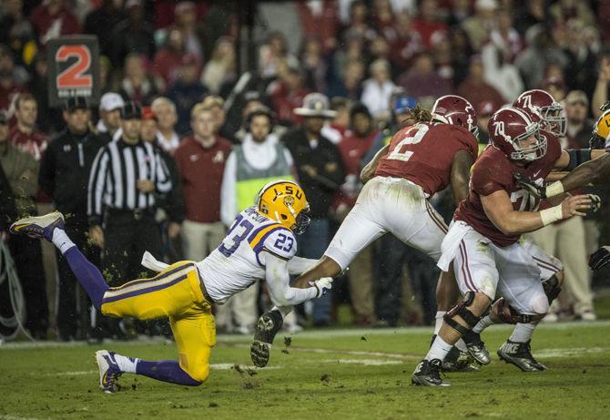 LSU junior saftey Corey Thomson (23) attempts to tackle Alabama junior running back Derrick Henry (2) during the Tigers' 30-16 defeat against the Crimson Tide on Saturday, Nov. 7, 2015 in the Bryant-Denny Stadium.