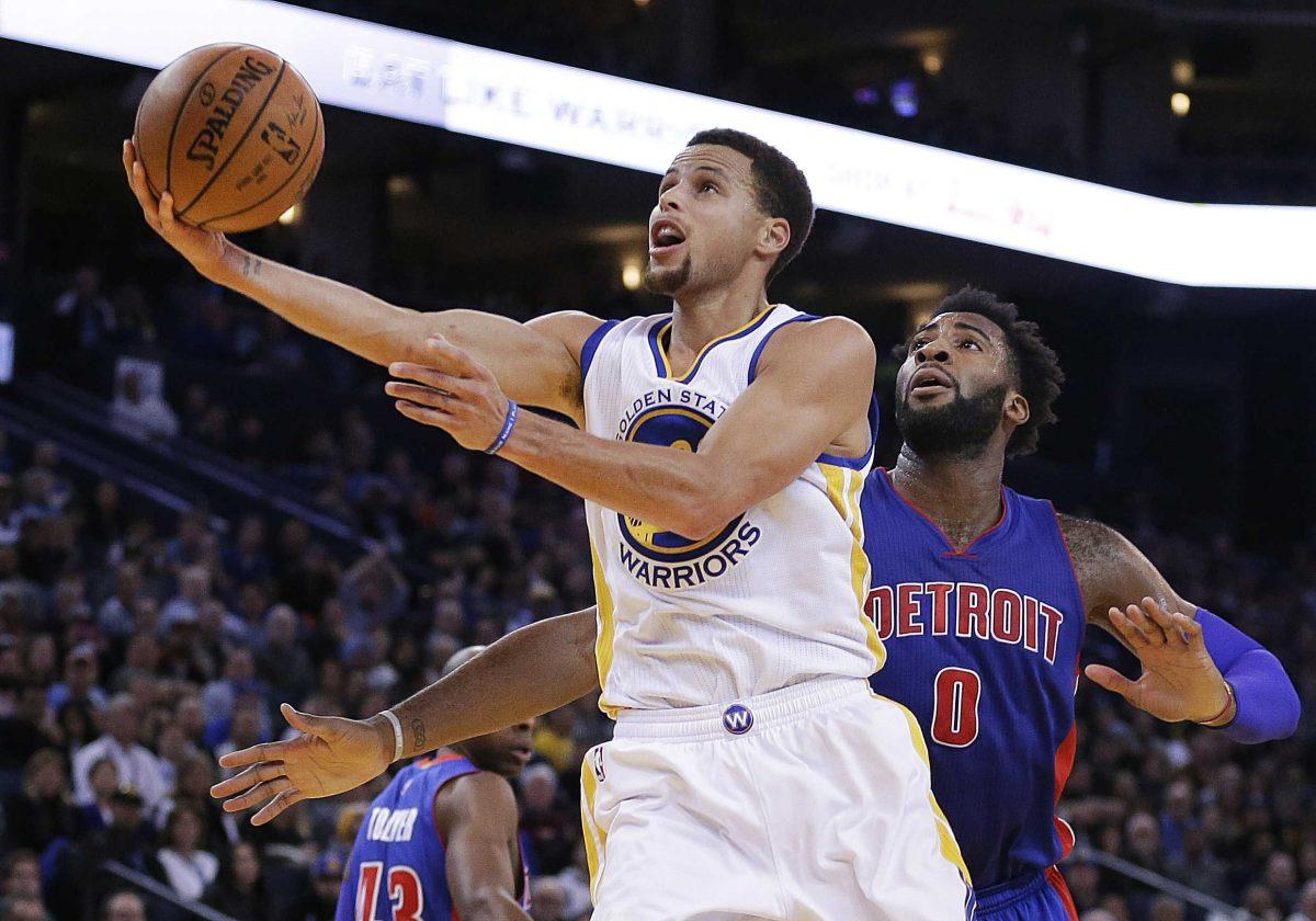 Golden State Warriors' Stephen Curry, left, lays up a shot past Detroit Pistons' Andre Drummond (0) during the second half of an NBA basketball game Monday, Nov. 9, 2015, in Oakland, Calif. The Warriors won 109-95. (AP Photo/Ben Margot)