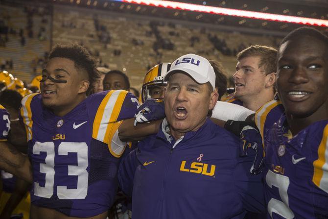 LSU head coach Les Miles sings alongside sophomore safety Jamal Adams (33) and freshman cornerback Kevin Toliver II (2) during the Tigers&#8217; 44-22 victory against Eastern Michigan on Saturday, Oct. 03, 2015 in Tiger Stadium.