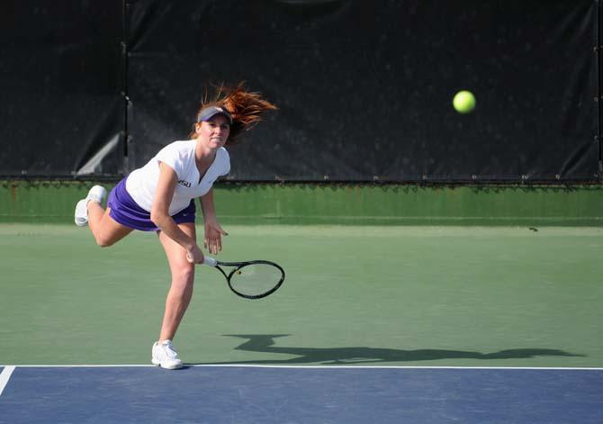 LSU freshman Abigail Owens serves the ball Friday, March 21, 2014 during a doubles match against Mississippi State at W.T. "Dub" Robinson Stadium.