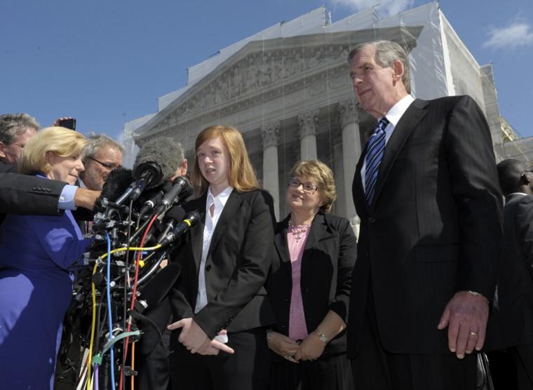 Abigail Fisher, the Texan involved in the University of Texas affirmative action case, accompanied by her attorney Bert Rein, right, talks to reporters outside the Supreme Court in Washington, Wednesday, Oct. 10, 2012. The Supreme Court is taking up a challenge to a University of Texas program that considers race in some college admissions. The case could produce new limits on affirmative action at universities, or roll it back entirely. The University of Texas at Austin President Bill Powers is at right.(AP Photo/Susan Walsh)