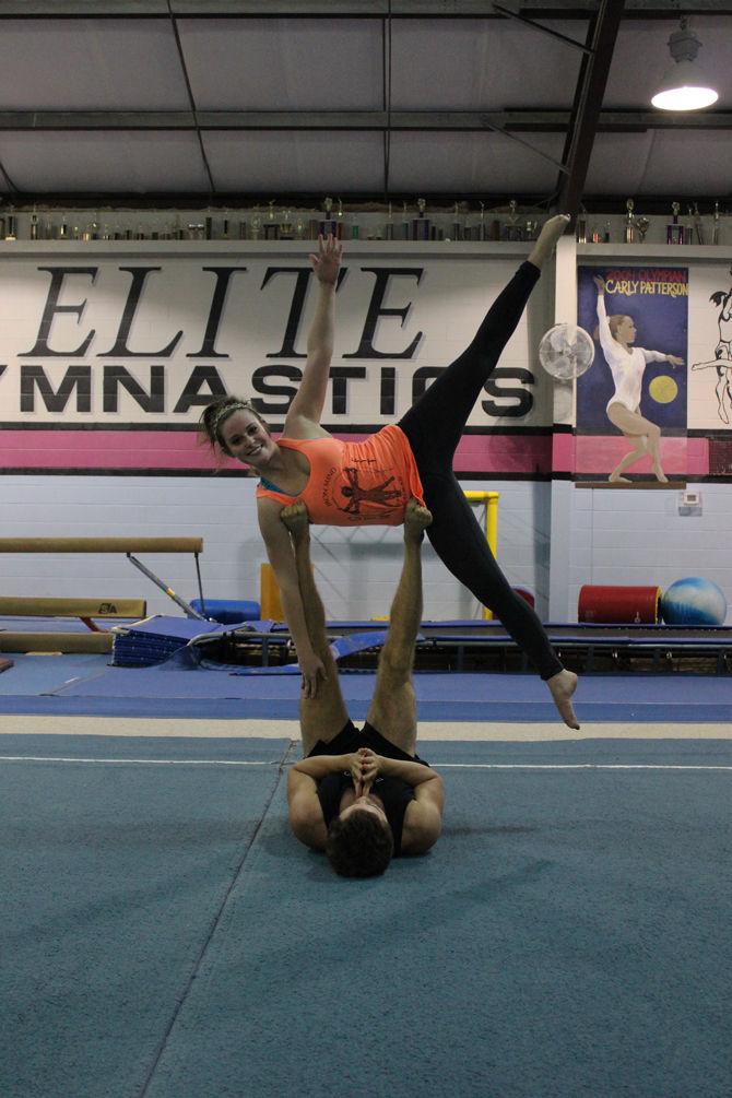 Acroyoga instructer Joshua Roberts and LeeEllen Hutchinson practice their yoga poses.