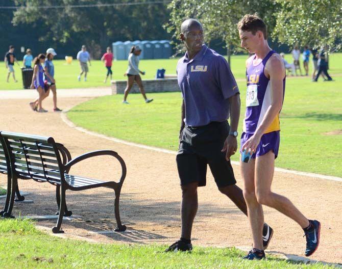 LSU cross country coach Khadevis Robinson speaks to a runner Saturday, Sep. 20, 2014 during the LSU Invitational at Highland Road Park.