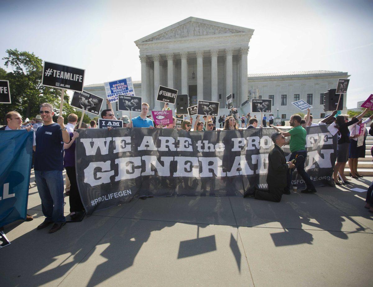 FILE - In this June 30, 2014 file photo, demonstrators stand on the steps outside the Supreme Court in Washington, where the court was poised to deliver its verdict in a case that weighs the religious rights of employers and the right of women to the birth control of their choice. The Supreme Court is wading into its fourth dispute over President Barack Obama&#8217;s 5-year-old health care overhaul. The newest &#8220;Obamacare&#8221; case involves objections by faith-based hospitals, colleges and charities to the process the administration devised to spare them from paying for contraceptives for women covered under their health plans, and yet ensure that those women can obtain birth control at no extra cost. (AP Photo/Pablo Martinez Monsivais, File)