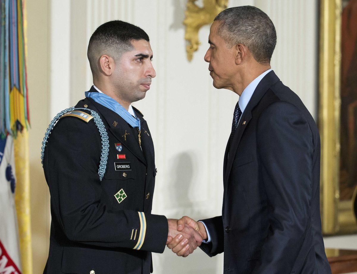 President Barack Obama, shakes hands with retired Army captain Florent Groberg, after bestowing the nation's highest military honor, the Medal of Honor to Groberg during a ceremony in the East Room of the White House in Washington, Thursday, Nov. 12, 2015. The former Army captain received the medal after he tackled a suicide bomber while serving in Afghanistan. (AP Photo/Pablo Martinez Monsivais)