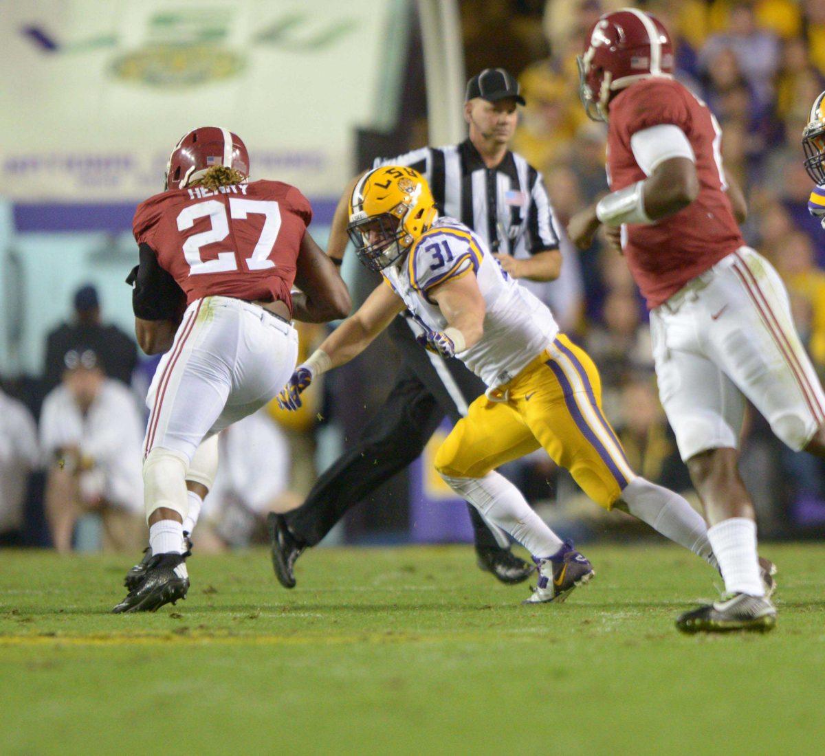 LSU Football player D.J. Welter (#31) attempts to tackel an Alabama player in the LSU vs Alabama game at Tiger Stadium Saturday night, November 8, 2014.