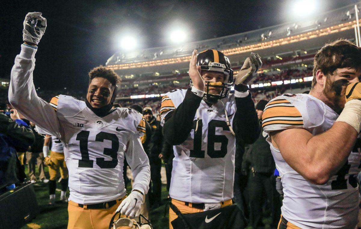 Iowa defensive back Greg Mabin (13) and quarterback C.J. Beathard (16) celebrate a 28-20 win over Nebraska in an NCAA college football game in Lincoln, Neb., Friday, Nov. 27, 2015. (AP Photo/Nati Harnik)