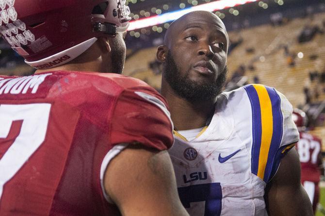 LSU sophomore running back Leonard Fournette (7) is approached by sophomore defensive lineman Tevin Beanum (97) after the Tigers' 31-14 defeat against the University of Arkansas on Nov. 14. 2015 in Tiger Stadium.