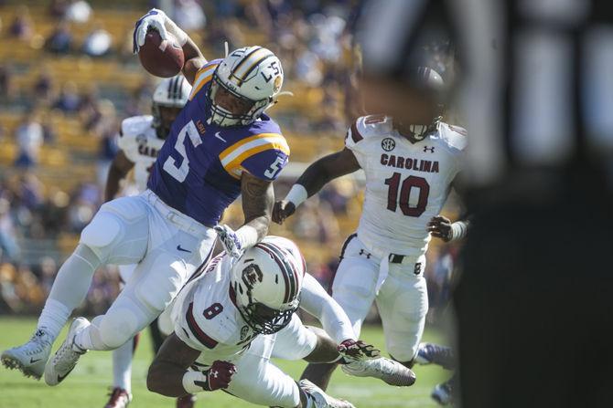 LSU freshman running back Derrius Guice (5) is pushed out of bounds by University of South Carolina junior defensive end Marquavius Lewis (8) during the Tigers&#8217; 45-24 victory on Saturday, Oct. 10, 2015 in Tiger Stadium.