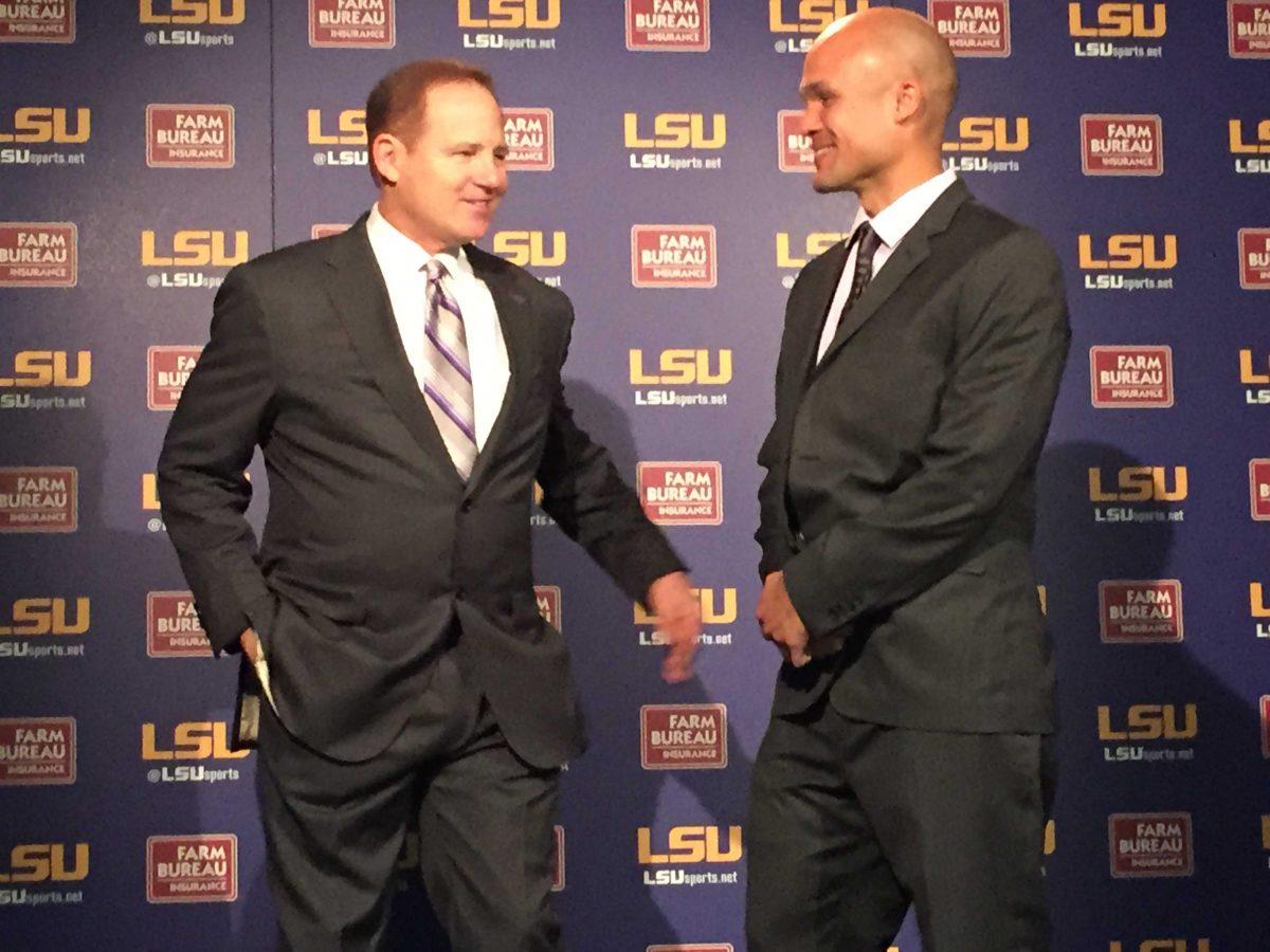 LSU football coach Les Miles and defensive coordinator Dave Aranda pose for pictures following Aranda's introduction as the new defensive coordinator on Tuesday, Jan. 5, 2015 at the Athletic Administration Building.