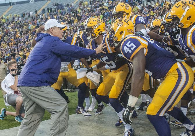 LSU head coach Les Miles holds his players off before taking the field during the Tigers&#8217; 48- 20 victory against Western Kentucky on Saturday, Oct. 24, 2015 in Tiger Stadium.