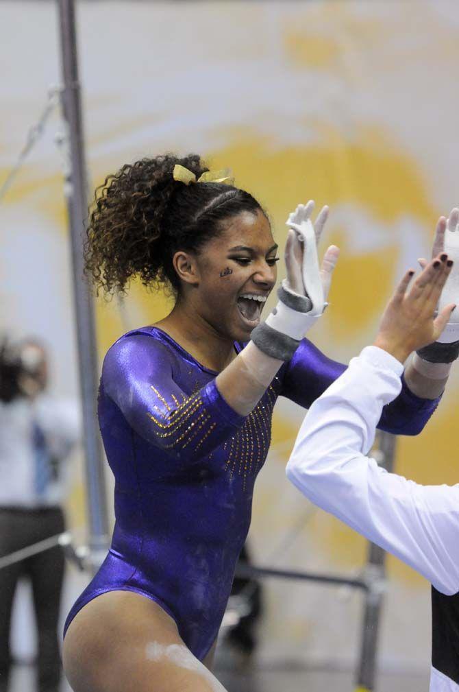 LSU junior Randii Wyrick celebrates after her bar routine on Friday, Jan. 9, 2015, during the Lady Tiger's 197-193 victory against Iowa in the PMAC