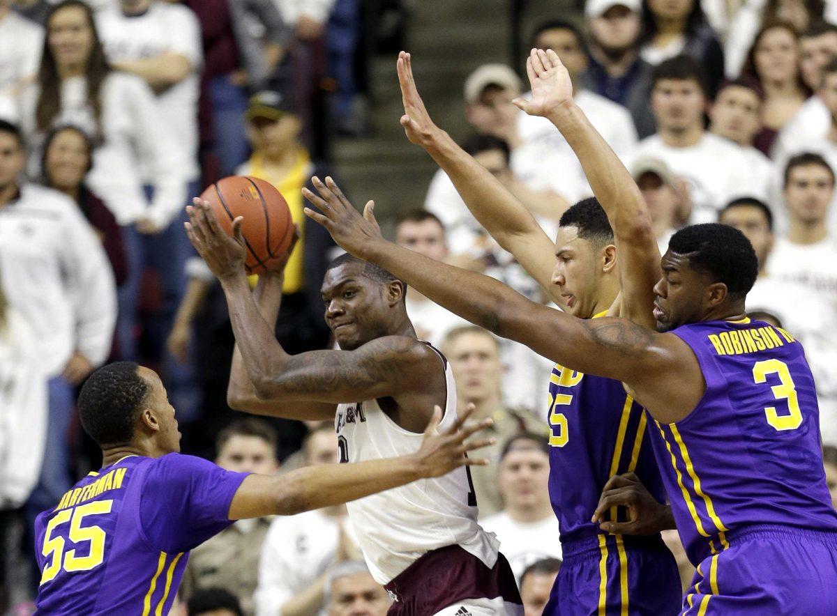 Texas A&amp;M's Jalen Jones, center, looks to pass the ball as LSU's Tim Quarterman (55), Elbert Robinson III (3) and Ben Simmons (25) defend during the second half of an NCAA college basketball game Tuesday, Jan. 19, 2016, in College Station, Texas. Texas A&amp;M won 71-57. (AP Photo/David J. Phillip)