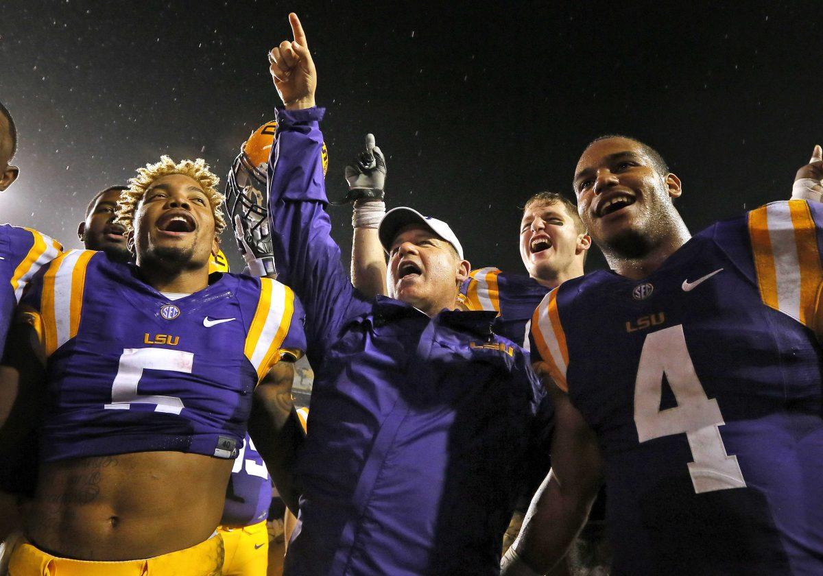 LSU head coach Les Miles, center, sings the school alma mater with the team after an NCAA college football game against Western Kentucky in Baton Rouge, La., Saturday, Oct. 24, 2015. LSU won 48-20. (AP Photo/Jonathan Bachman)