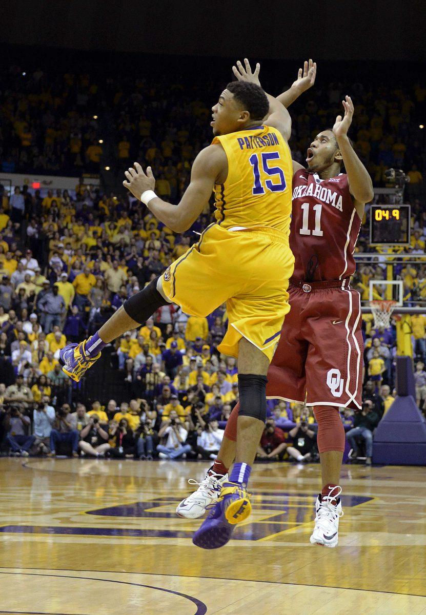 LSU guard Jalyn Patterson (15) and Oklahoma guard Isaiah Cousins (11) watch Cousins' go-ahead basket in the closing seconds of an NCAA college basketball game in Baton Rouge, La., Saturday, Jan. 30, 2016. Oklahoma won 77-75. (AP Photo/Bill Feig)