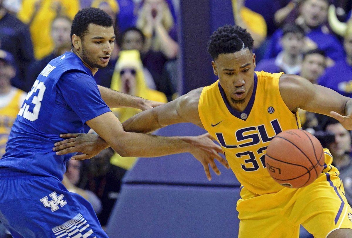 Kentucky guard Jamal Murray (23) and LSU forward Craig Victor II (32) scramble for control of a rebound during the second half of an NCAA college basketball game in Baton Rouge, La., Tuesday, Jan. 5, 2016. LSU won 85-67. (AP Photo/Bill Feig)