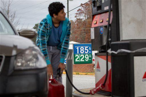 FILE - In this Wednesday, Nov. 25, 2015, file photo, Cornelio Bonilla pumps gas at Best Food Mart gas station in Gainesville Ga. Sinking oil prices have cratered the stock market, but a silver lining may soon appear. Cheaper gasoline and heating oil will give consumers worldwide more money to spend, or save and spend later, and possibly boost economic growth in the U.S., Europe and much of Asia. (AP Photo/Kevin Liles, File)