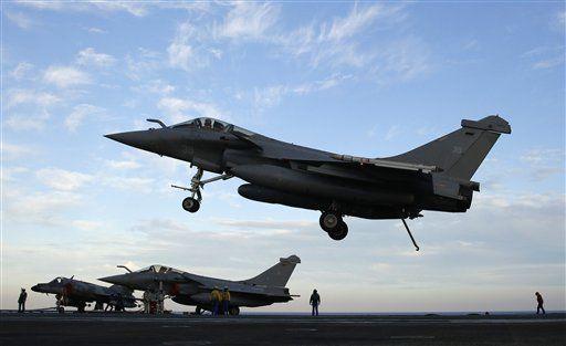 A Rafale fighter jet lands after a mission, on France's flagship Charles de Gaulle aircraft carrier in the Persian Gulf, Tuesday, Jan. 12, 2016. The Charles de Gaulle joined the U.S.- led coalition against Islamic State in November, as France intensified its airstrikes against extremist sites in Syria and Iraq in response to IS threats against French targets. (AP Photo/Christophe Ena)