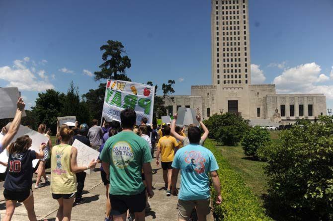 Protestors march towards the Louisiana State Capitol building Thursday, Apr. 30, 2015 in protest of higher education budget cuts.