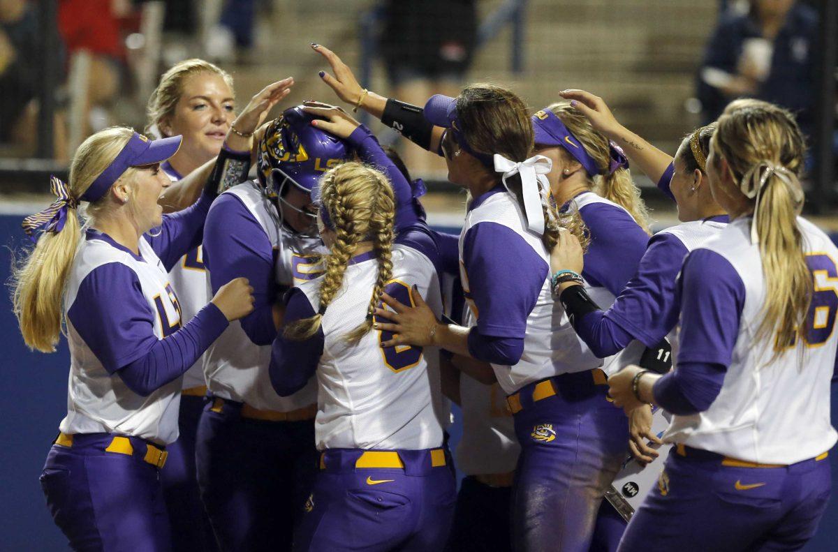 LSU celebrates a run by Bianka Bell (27) during an NCAA Women's College World Series game against Alabama in Oklahoma City, Saturday, May 30, 2015. (Sarah Phipps/The Oklahoman via AP) LOCAL STATIONS OUT (KFOR, KOCO, KWTV, KOKH, KAUT OUT); LOCAL WEBSITES OUT; LOCAL PRINT OUT (EDMOND SUN OUT, OKLAHOMA GAZETTE OUT) TABLOIDS OUT