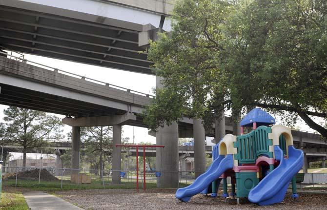 A playground sits underneath I-10 on Wednesday, April 2, 2014, in Old South Baton Rouge.