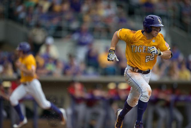 LSU Junior Infielder Cole Freeman (22) racing toward first base during the Tiger's 12-4 victory against The University of Cincinnati on Sunday, Feb. 21, 2016 at the Alex Box Stadium