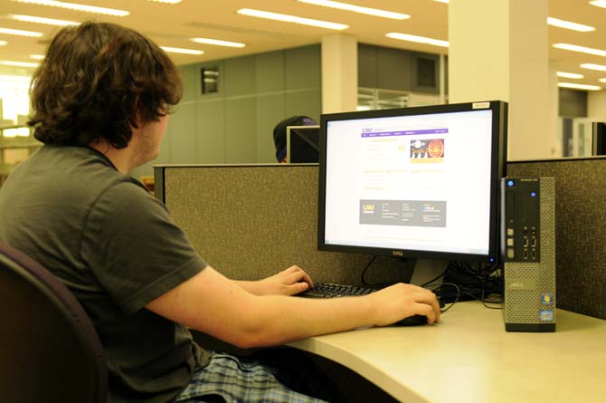 A student using a computer inside of Middleton Library.