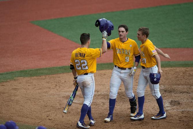 LSU Freshman Infielder O'Neal Lochridge (9) being congratulated by his teammates during the Tiger's 12-4 victory against The University of Cincinnati on Sunday, Feb. 21, 2016 at the Alex Box Stadium