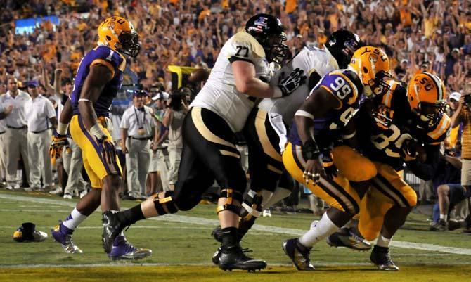 Senior defensive end Lavar Edwards (89) runs in for a touchdown after intercepting the football Saturday, September 15, 2012 during the Tigers' 63-14 win over Idaho in Tiger Stadium.