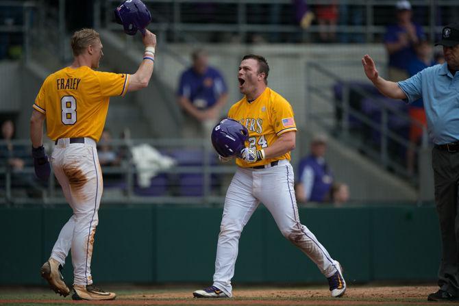 LSU sophomore outfielder Beau Jordan (24) celebrating his home run with junior outfielder Jake Fraley (8) during the Tiger's 12-4 victory against The University of Cincinnati on Sunday, Feb. 21, 2016 at the Alex Box Stadium.