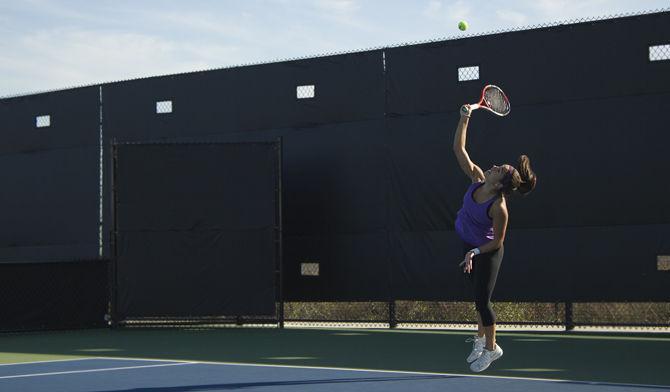 Junior Joana Vale Costa practices her serve during practice, Jan. Tuesday 12, 2016, LSU Tennis Complex.