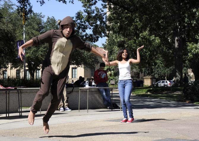 Jose Lloveras-Fuentes, a Theater Senior, and Bianca Dixon, a Biology Freshman, participate in a flash mob with HSCS on Tuesday at Free Speech Plaza.