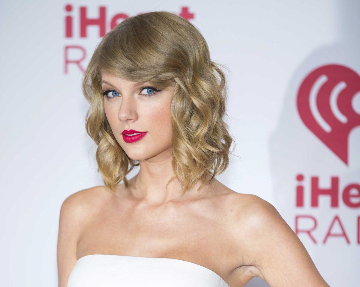 FILE - In this Sept. 19, 2014 file photo, Taylor Swift arrives at the iHeart Radio Music Festival in Las Vegas. The music streaming service Spotify is no longer offering Swift songs at her request, setting up a battle between the industry's most popular artist and the leading purveyor of a new music distribution system. Spotify, which pulled Swift's songs on Monday, Nov. 3, 2014, said that "we hope she'll change her mind and join us in building a new music economy that works for everyone." (Photo by Andrew Estey/Invision/AP, File)