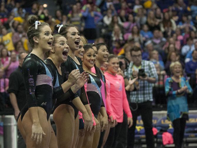 The LSU gymnastics team cheers on all-around junior Ashleigh Gnat as she performs a floor routine during the Tigers' 196.575-195.100 victory against Kentucky for the Pink &amp; Blue Meet on Friday, Jan. 22, 2016 in the PMAC.