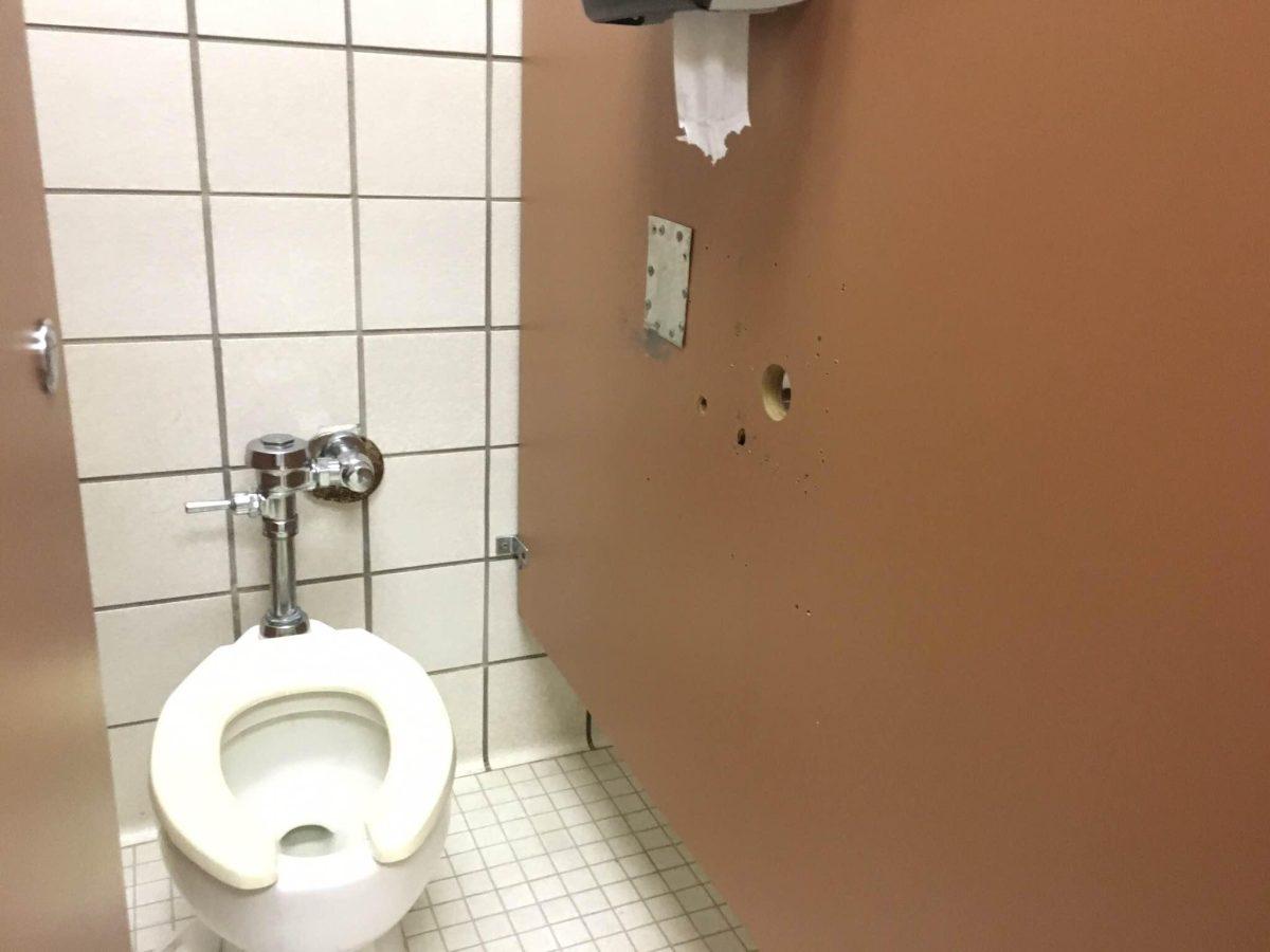 Hole in a Men's Restroom Stall