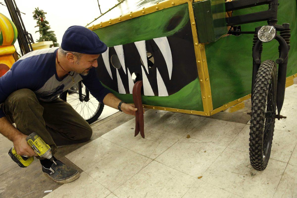 Ryan Ballard, founder of the Krewe of Chewbacchus Mardi Gras parade, makes adjustments to a hand made silicone tongue on a float at their headquarters at the Castillo Blanco Art Studios in New Orleans, Saturday, Jan. 2, 2016. (AP Photo/Gerald Herbert)