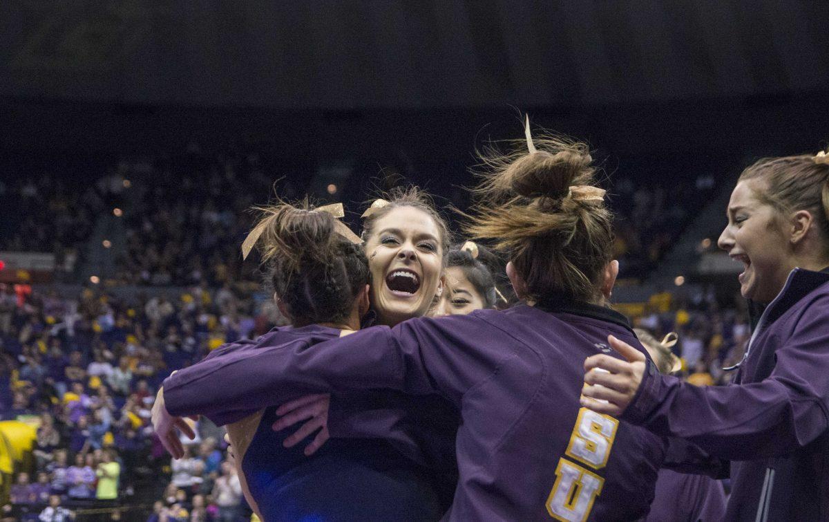 LSU junior Ashleigh Gnat is congratulated by her teammates after earning a perfect 10.0 for her floor rutine during the Tigers' 197.825-197.125 victory against Auburn on Friday, Feb. 19, 2016 in the PMAC.