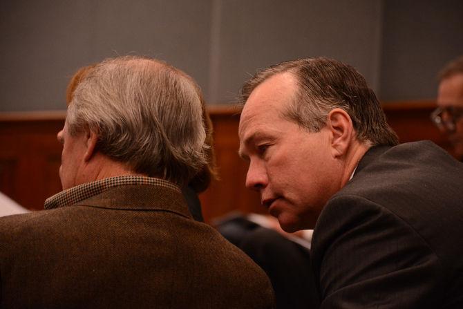 LSU President F. King Alexander confers with former Sen. Robert Adley, R-Benton, during the Revenue Estimating Conference Wednesday at the Louisiana Statehouse.