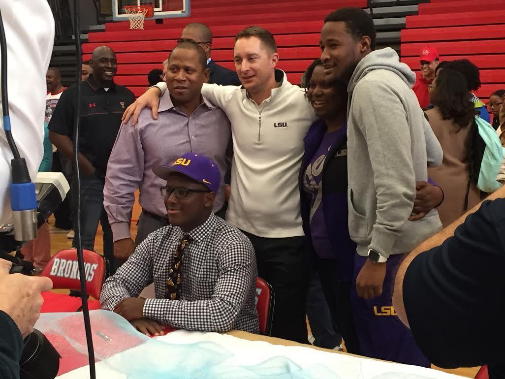 LSU quarterback signee Lindsey Scott Jr. poses with (left to right) his father, Lindsey Scott Sr., former Tiger quarterback and personal quarterback coach Tom Rathmann, his mother, Sonja Scott, and sophomore Tiger quarterback Brandon Harris at Scott Jr.'s signing day on Jan. 3 at Zachary High School.