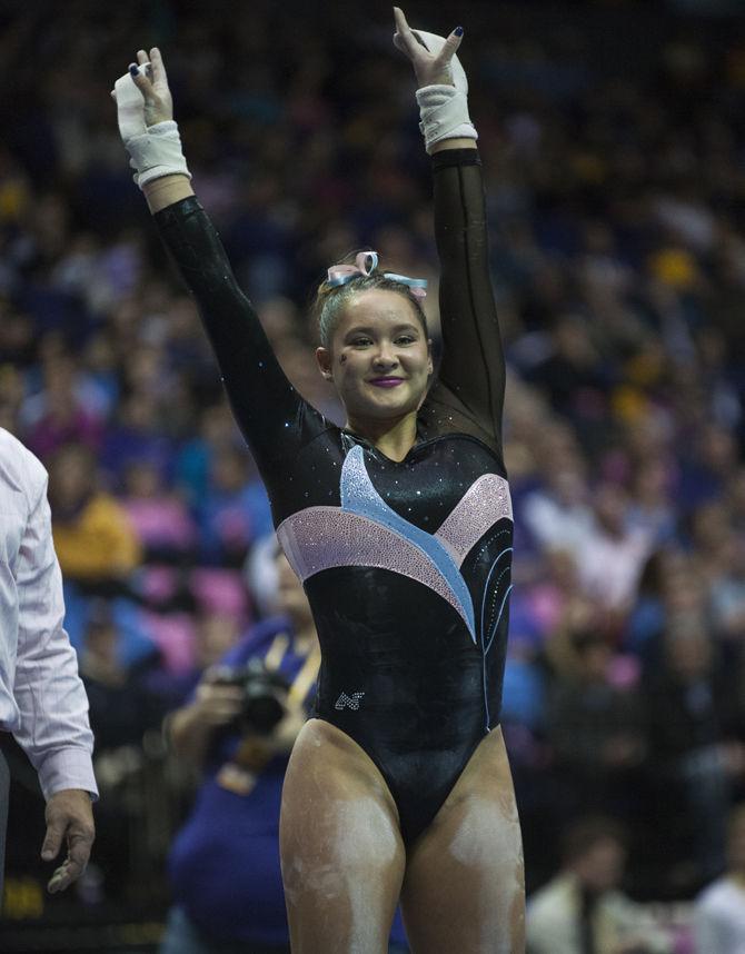 LSU all-around freshman Sarah Finnegan smiles after a bars routine during the Tigers' 196.575-195.100 victory against Kentucky for the Pink &amp; Blue Meet on Friday, Jan. 22, 2016 in the PMAC.