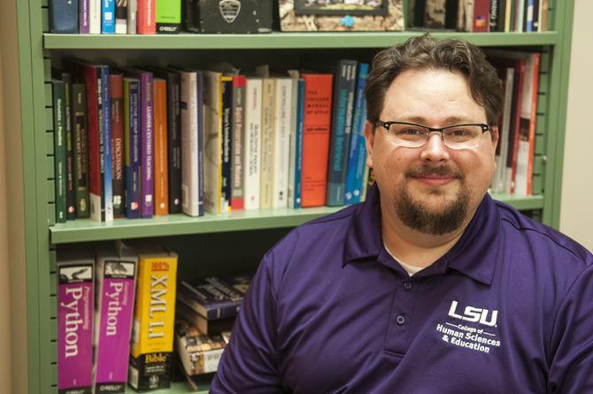 Assistant Professor Edward Benoit, III, pictured in his Coates Hall office Monday, Feb. 22, 2016, is working toward creating an application called the Virtual Footlocker Project that will capture and preserve the personal records of the modern soldier.