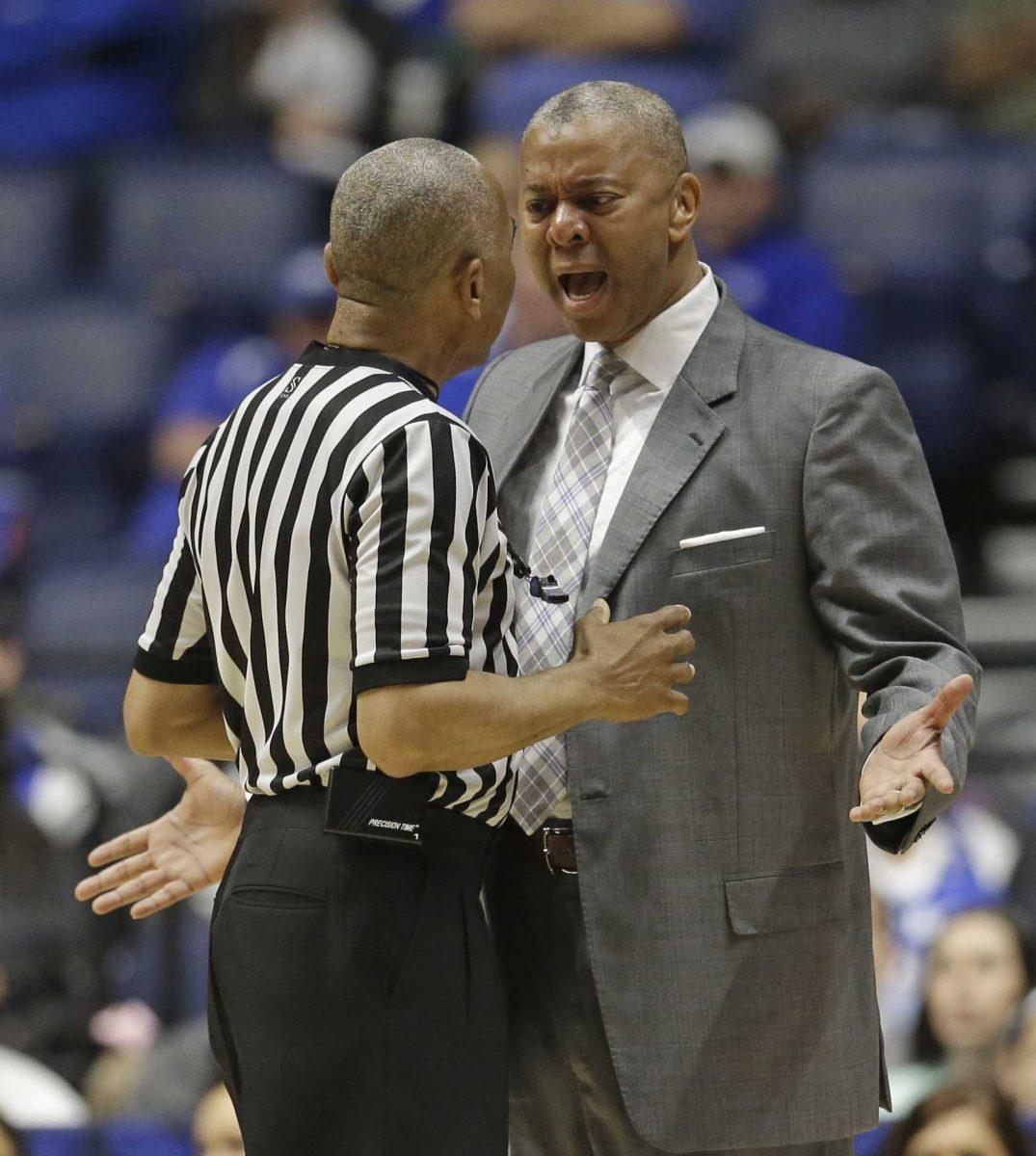 LSU head coach Johnny Jones, right, argues a call with an official during the first half of an NCAA college basketball game against Texas A&amp;M in the Southeastern Conference tournament in Nashville, Tenn., Saturday, March 12, 2016. (AP Photo/Mark Humphrey)