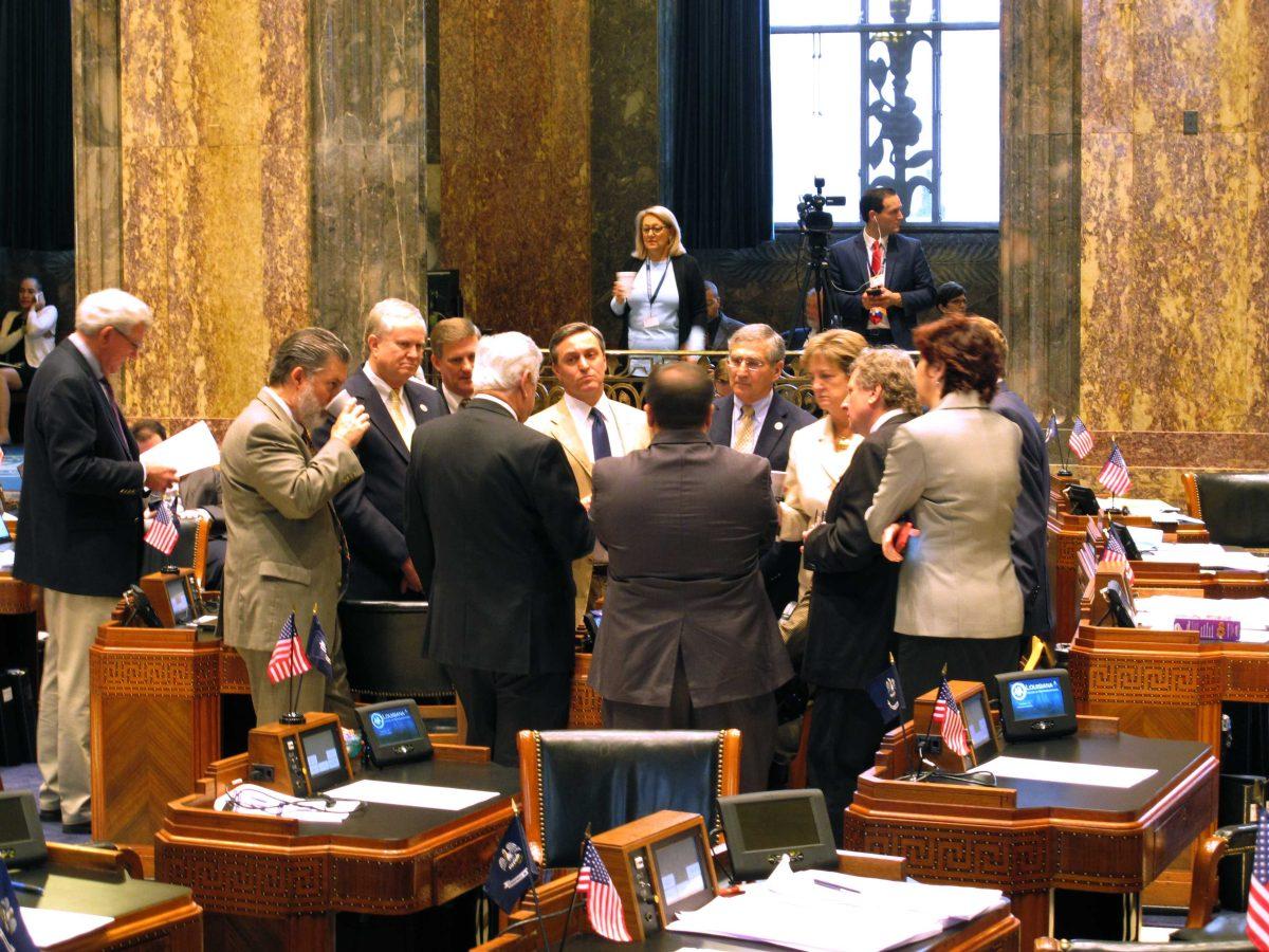 Senators meet with Senate President John Alario, R-Westwego, on the Senate floor ahead of the voting on the final day of a special legislative session on the budget and taxes, on Wednesday, March 9, 2016, in Baton Rouge, La. (AP Photo/Melinda Deslatte)