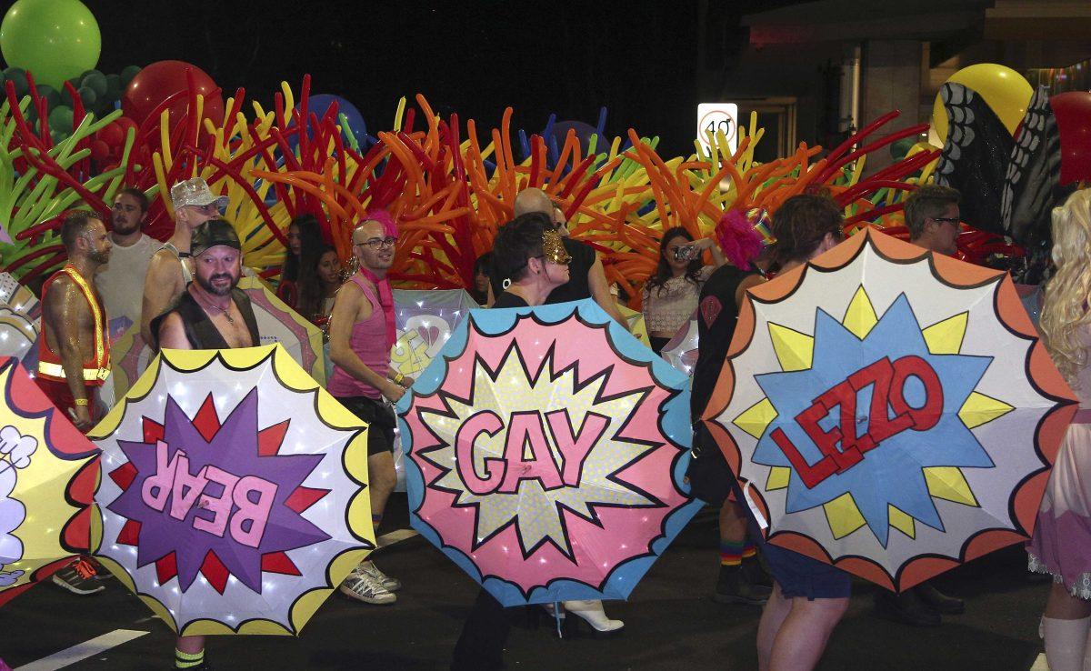 People carrying umbrellas and balloons march along a street during the 38th annual Gay and Lesbian Mardi Gras in Sydney, Australia, Saturday, March 5, 2016. According to the parade's organizers, this year's parade includes more than 170 floats and thousands of supporters from Australia and overseas. (AP Photo/Rob Griffith)