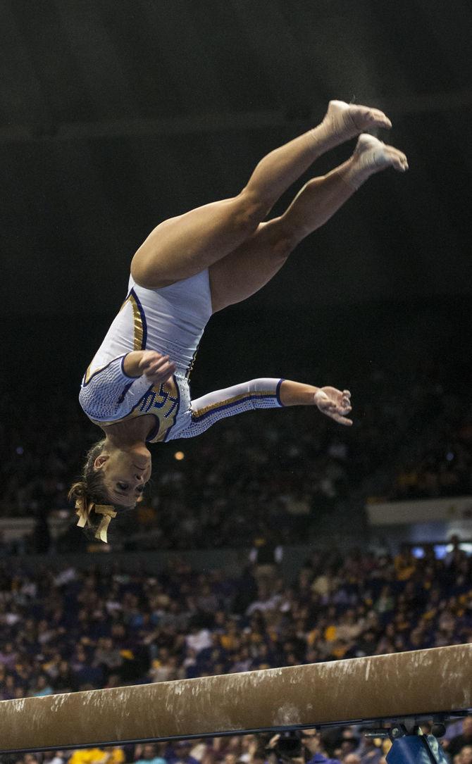 LSU all-around junior Sydney Ewing flips on the beam Friday, March 4, 2016, during the Tigers' 197.925-196.225 victory against Alabama in the PMAC.