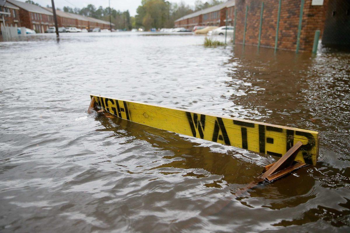 Flood waters partially submerge a "HIGH WATER" sign on Rufus Bankston Road west of Hammond, La., on Friday, March 11, 2016. (David Grunfeld/NOLA.com The Times-Picayune via AP) MAGS OUT; NO SALES; USA TODAY OUT; THE BATON ROUGE ADVOCATE OUT; THE NEW ORLEANS ADVOCATE OUT; MANDATORY CREDIT