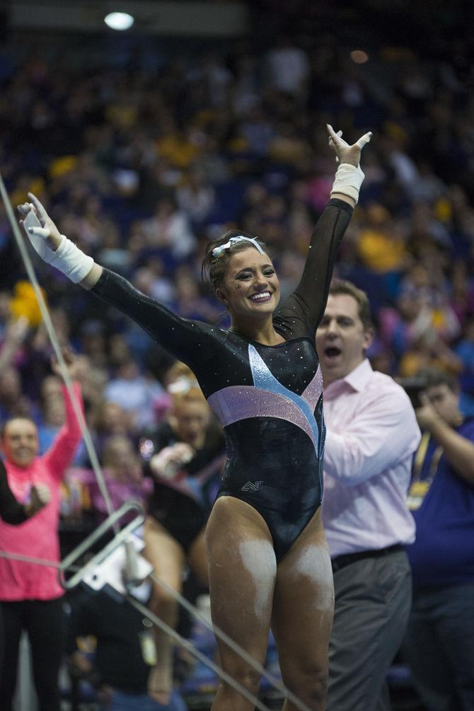 LSU all-around freshman Lexie Priessman smiles at the judges after a bars routine during the Tigers' 196.575-195.100 victory against Kentucky for the Pink &amp; Blue Meet on Friday, Jan. 22, 2016 in the PMAC.