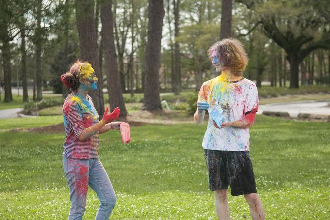 Students throw colored dye to celebrate Holi festival