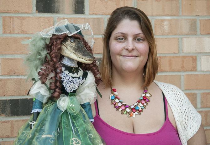 Anthropology student Emeral DeLorenzo-Brown displays her alligator doll Tuesday, March 15, 2016 at her home. She creates alligator dolls as part of her Oddly Unique Creations business.